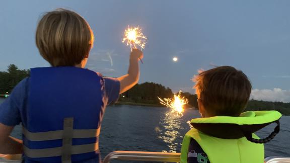 Kids watching fireworks on lake