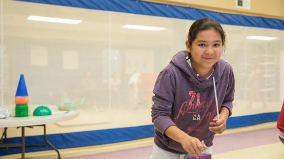 Young girl painting at Akwesasne Boys + Girls Club