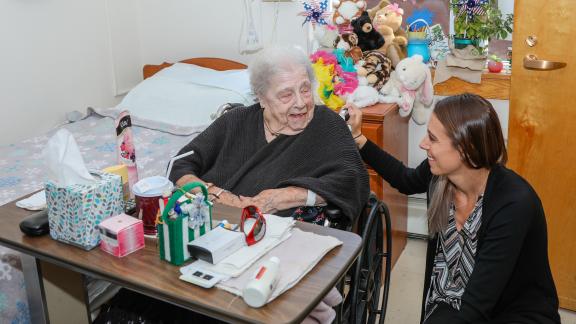 Clifton Fine Hospital volunteer with resident 